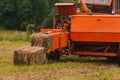 Old red tractor in the field, Ukrainian fields and old machinery, hay harvesting in the field