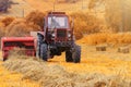 Old red tractor in the field, Ukrainian fields and old machinery, hay harvesting in the field Royalty Free Stock Photo