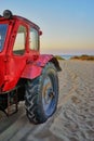 Old red tractor in the sand at the beach in Ahlbeck. Germany Royalty Free Stock Photo