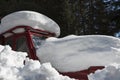 Old red tractor trapped under the snowdrift in the in forest of Rodopi mountain