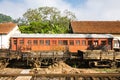 An old red train car sits abandoned in Kandy railway station, Sr