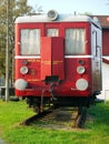 Old red train waggon at piece of rail