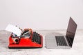 Old typewriter and laptop on table. Concept of technology progress Royalty Free Stock Photo