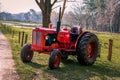 Old red vintage tractor on the land Royalty Free Stock Photo