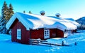 Old red wooden cabin in the wild covered in snow from a recent blizzard Royalty Free Stock Photo