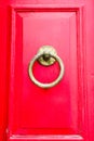 Old red wooden door with round vintage bronze door handle, Mgarr, Malta Royalty Free Stock Photo