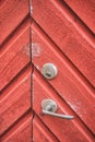 Old red wooden door texture background with door knob and rusty padlock. Royalty Free Stock Photo