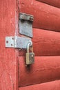Old red wooden door texture background with door knob and rusty padlock. Royalty Free Stock Photo