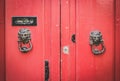 Old Red Wooden Doors with Lion Head Metal Knockers in Mdina, Malta Royalty Free Stock Photo