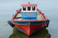 Old wooden fishing boat anchored at sea Royalty Free Stock Photo