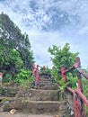 Old Red Wooden Hand Stairs at Karang Bolong Under Blue Sky