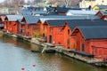 Old red wooden houses on the river coast on a cloudy day Royalty Free Stock Photo