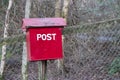 Old red wooden post box in countryside for mail and letters Royalty Free Stock Photo