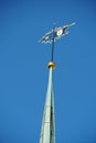 Old reformed church tower in Urdorf, Switzerland detail or close up on the wind pointer or wind pointer decorated with golden smit