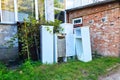 Old refrigerators under a building. A dump of abandoned household appliances Royalty Free Stock Photo