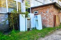 Old refrigerators under a building. A dump of abandoned household appliances Royalty Free Stock Photo