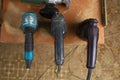 Old reliable corded power tool in workshop. Handles for drills and screwdrivers. Selective focus background