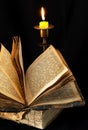 Old religious book and candle Royalty Free Stock Photo