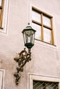 An old residential building with a bracket in the wall for a street lamp in the daytime.
