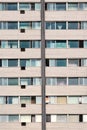 Old residential building facade with windows and air conditioners Royalty Free Stock Photo