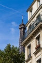 Old residential building front, with Eiffel tower in background, Paris