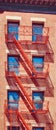 Old residential building with red fire escapes, New York City, USA Royalty Free Stock Photo