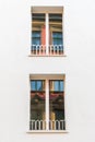 An old residential building is reflected in two windows Royalty Free Stock Photo