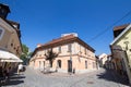 Old residential building on Trubarjeva cesta street at summer with people passing by and a nearby bar cafe. Royalty Free Stock Photo