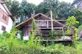 Old Resort or abandoned wood one floors level house in disrepair green trees and vines cover it. Royalty Free Stock Photo