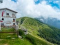 Old restaurant building to be refurbished in the mountains of Monte Baldo in Malcesine in Italy in a green meadow