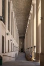 Old restored building - massive columns and a long corridor. Ancient architecture. Royalty Free Stock Photo