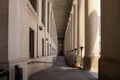 Old restored building - massive columns and a long corridor. Ancient architecture. Royalty Free Stock Photo