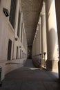 Old restored building - massive columns and a long corridor. Ancient architecture. Royalty Free Stock Photo