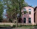 Pink House with Blue Trim & Cream Picket Fence Royalty Free Stock Photo