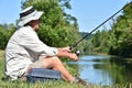 Old Retiree Outdoorsman Resting With Fishing Rod Fishing