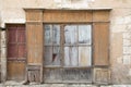 Old retro abandoned wooden facade of an ancient worn wooden shop store brown in France Europe