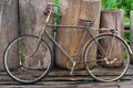 An old retro antique vintage bicycle leaning against wooden fence Royalty Free Stock Photo