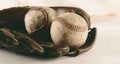 Old retro baseball glove with balls closeup