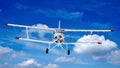 Old retro bi plane fly in the clouds. Royalty Free Stock Photo