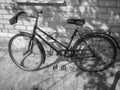 Old retro bicycle on brick wall. Photo in black and white style Royalty Free Stock Photo