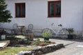 Old retro bicycle leaning against a wall, chairs and table defrost house Royalty Free Stock Photo