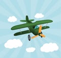 Green cartoon plane flying over sky with clouds. Old retro biplane designed for poster printing. Model aircraft, two wings Royalty Free Stock Photo