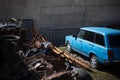 Old retro blue car at the scrap dump