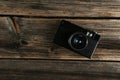 Old retro camera on brown wooden background. Royalty Free Stock Photo
