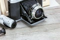 old retro camera, negative films and photo frame on wooden background Royalty Free Stock Photo