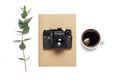 Old retro camera notebook diary cup of coffee eucalyptus leaves on white background. Flat lay top view copy space. Stylish minimal Royalty Free Stock Photo