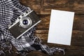 Old retro camera on vintage brown wooden board with black and white checkered scarf. abstract background. Top view.Copy space for Royalty Free Stock Photo