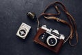 Old retro camera and vintage exposure meter on black background, flat lay Royalty Free Stock Photo