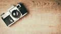 Old retro camera on vintage rustic wooden planks boards. Education photography courses back to school concept abstract background Royalty Free Stock Photo