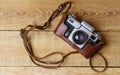 Old retro camera on vintage rustic wooden planks boards. Royalty Free Stock Photo